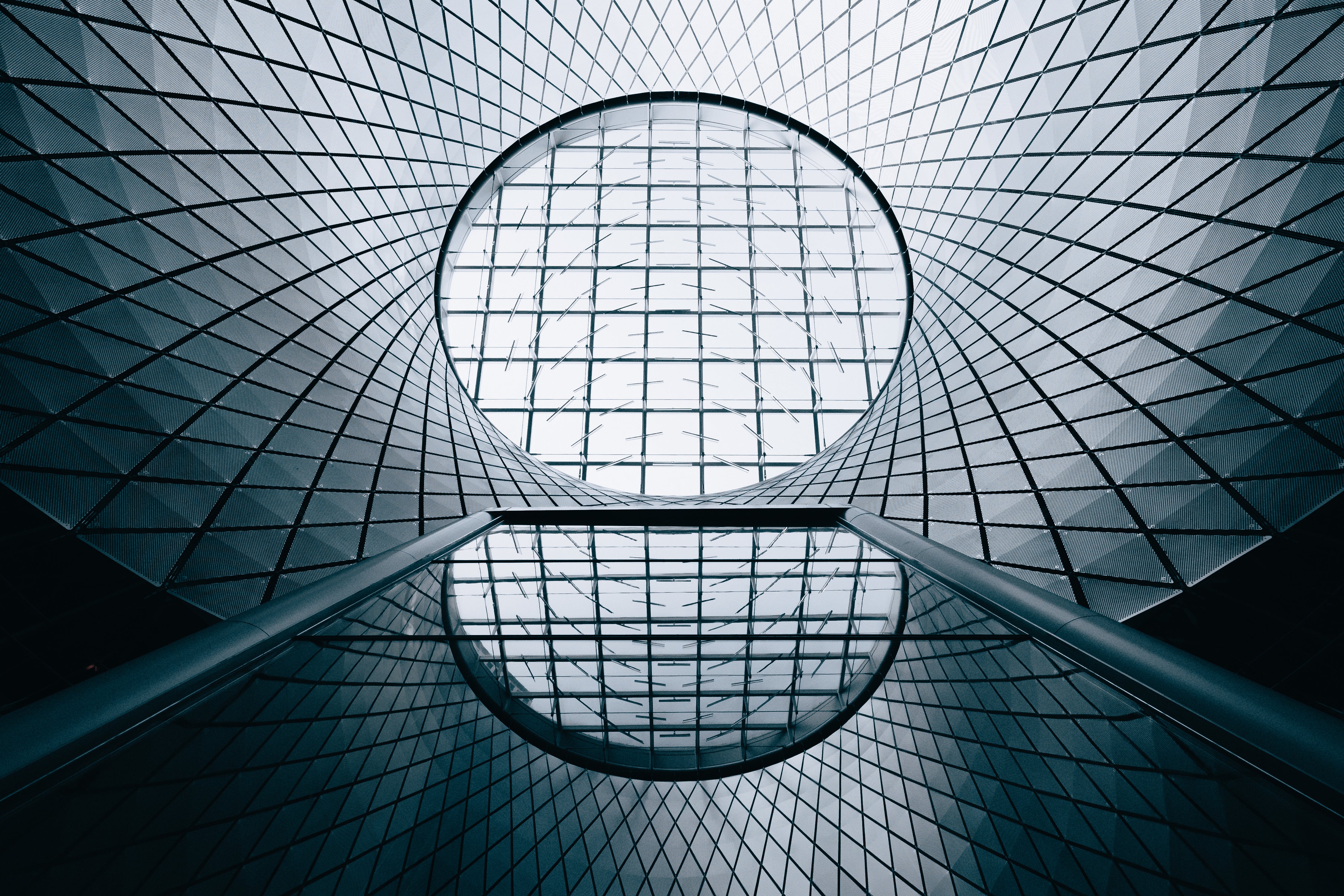 Looking up through a geometric glass-and-steel atrium roof