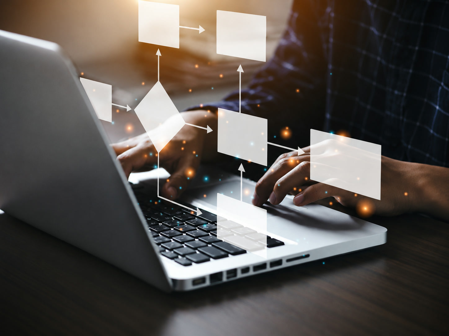 Hands typing on a laptop with a process flow diagram of connected steps floating above the keyboard