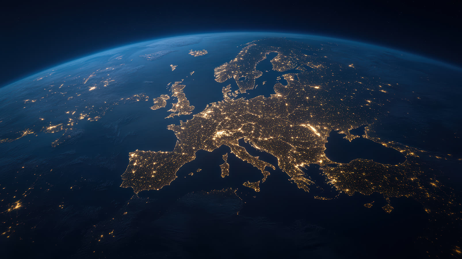 Europe at night seen from space, city lights spread across the continent